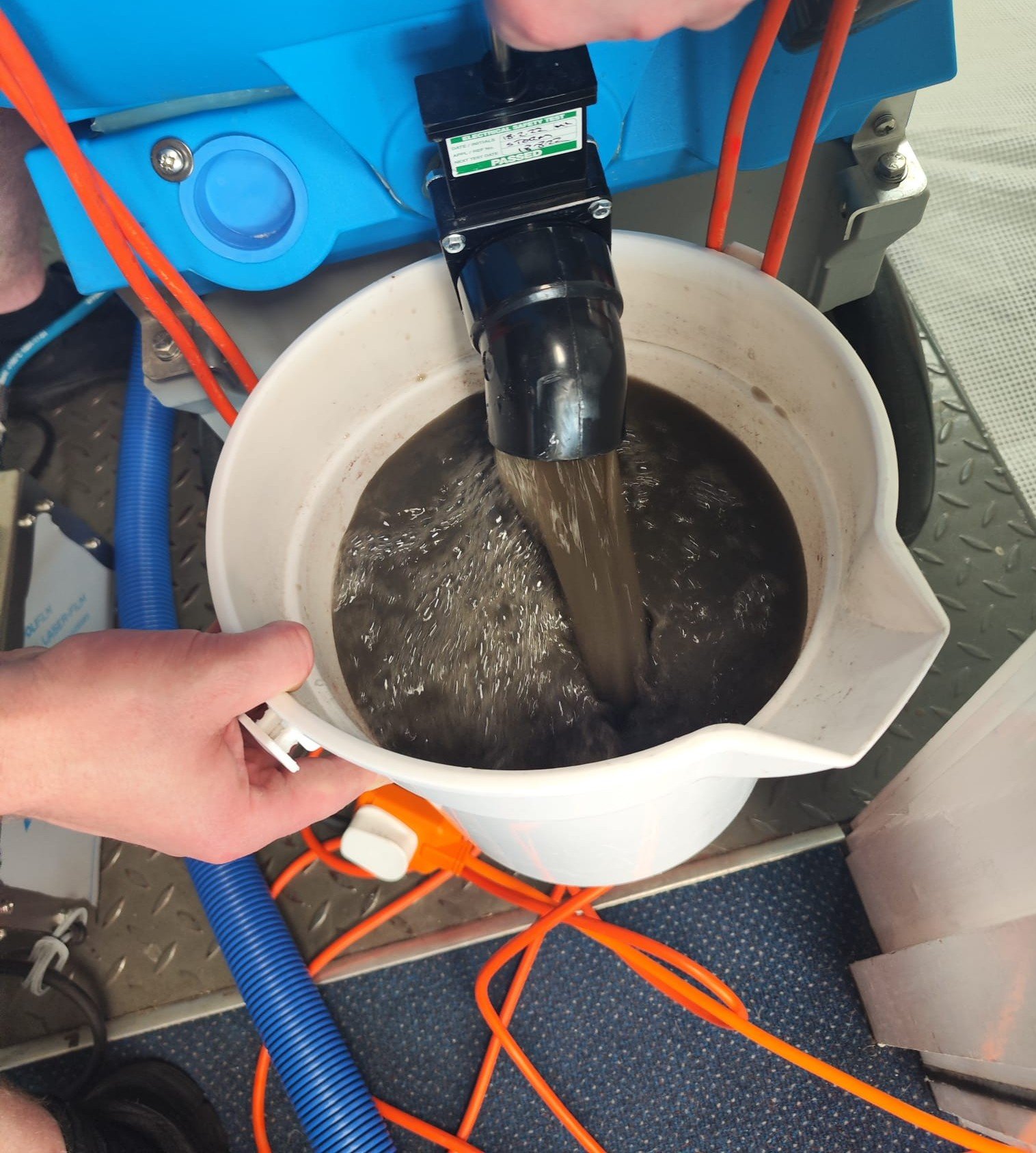 Dirty extraction water removed from carpets during professional cleaning